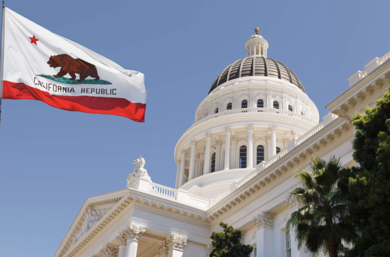 Photo of California flag and state legislature building.